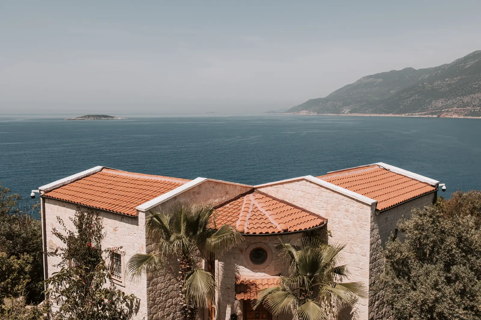 Olive Court on its terrace above the water, under a terracotta roof