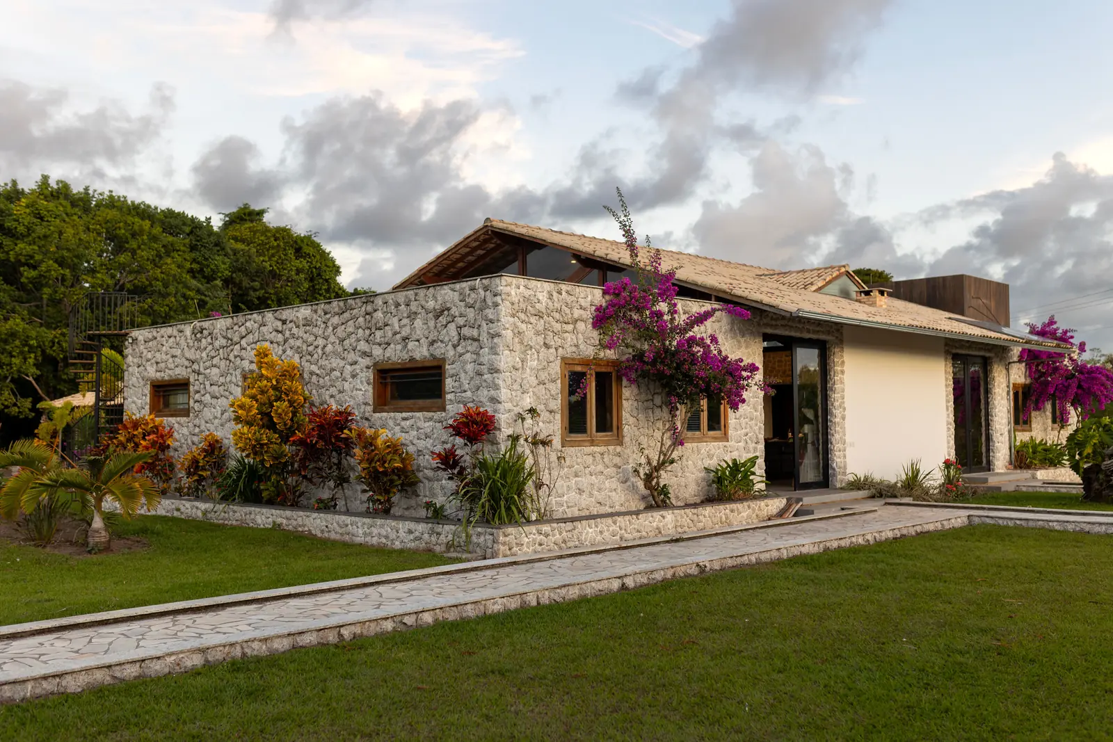 A residence at Saltmere Point, its stone wall planted along the top